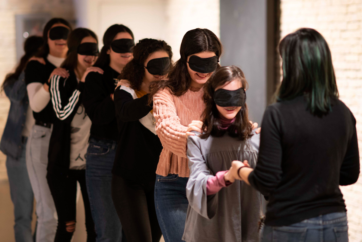 A group of youngsters are visiting the museum blindfolded.