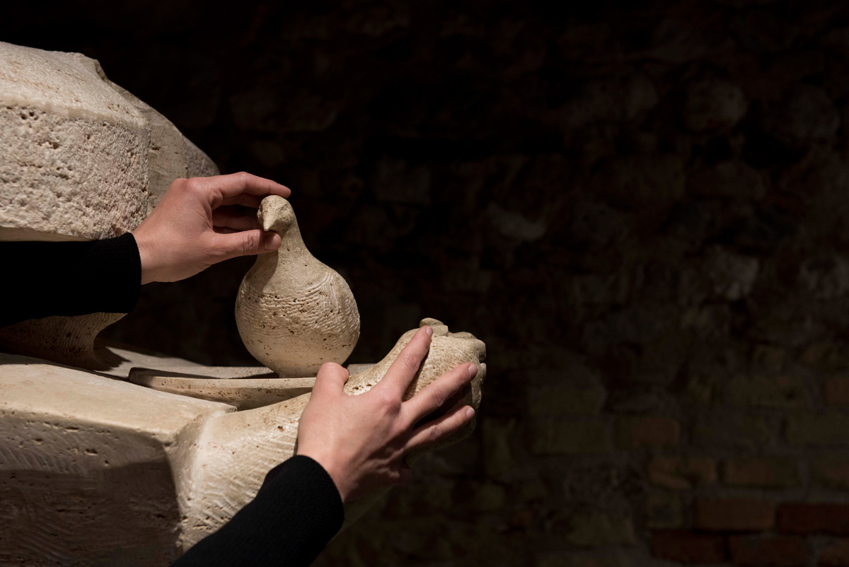 hands touching the Stele of Doves