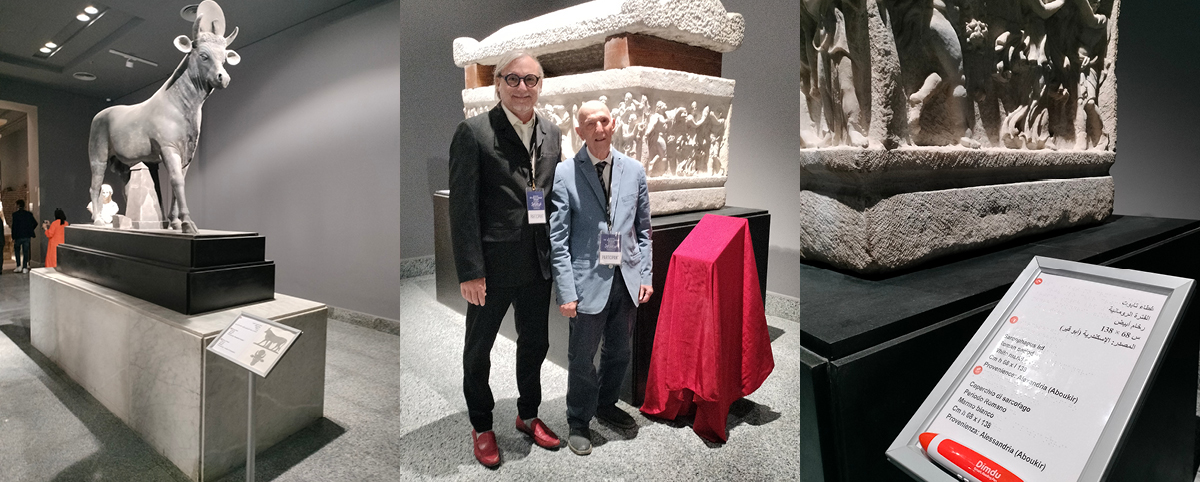 Andrea Socrati and Aldo Grassini near a sculpture with Braille captions in multiple languages.